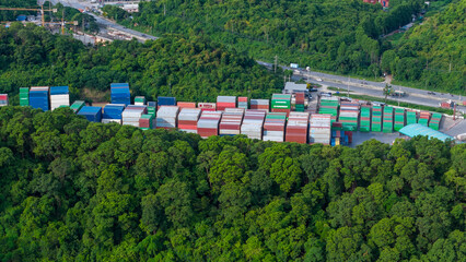 green transportation. Cargo Container yard next the road and surrounded by mountains , forklift...