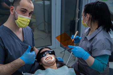 Dental Care Team Working on Patient's Oral Health with Professional Tools and Techniques for a...