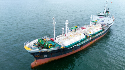 LPG tanker ship navigating calm blue waters near an offshore terminal. Ideal for themes on energy...