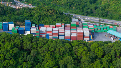 green transportation. Cargo Container yard next the road and surrounded by mountains , forklift...