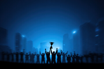 A trophy is held high as a team member is applauded, representing employee recognition and the achievement of success, celebrated by a group of cheering colleagues.