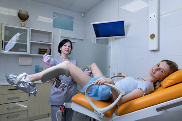 A Patient Preparing for a Procedure in a Modern Medical Office with a Caring Healthcare...