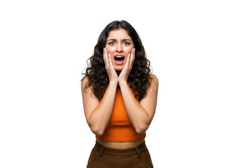 A young woman with curly hair expresses shock and fear, holding her hands to her face with her mouth open, isolated on a transparent background