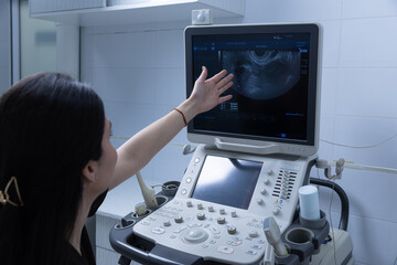 Medical Professional Using Ultrasound Equipment to Examine Patient Results in a Clinical Setting...