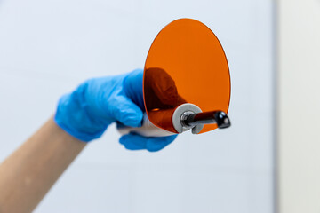 Innovative Medical Device Displayed in Professional Setting: Orange Optical Accessory with...