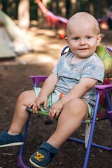 Baby boy relaxing on camping chair during family vacation