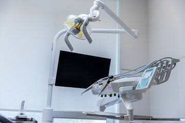 Modern Dental Chair Setup in a Bright Treatment Room Featuring Advanced Technology for Patient Care...