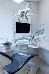 Modern Dental Office Interior Featuring a Comfortable Chair, Advanced Equipment, and Bright...