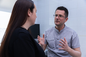 Doctor Engaged in Conversation with Patient in Modern Clinic Setting, Emphasizing Care and Empathy...