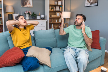 Young couple calling police to report domestic violence. Man and woman call 911 to report loud...