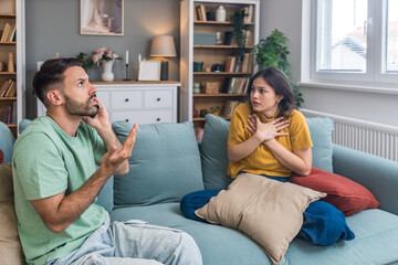 Young couple calling police to report domestic violence. Man and woman call 911 to report loud...