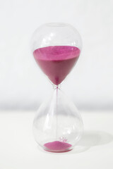 Hourglass, glass container with pink sand, marking the passage of time.jpg