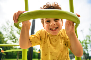 Happy kid on playground on summer season