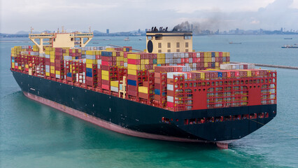 Stern of cargo ship carrying container and running for export goods from cargo yard port to custom...