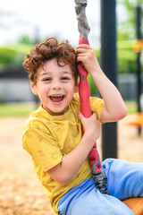Happy 5 years old boy on a playground