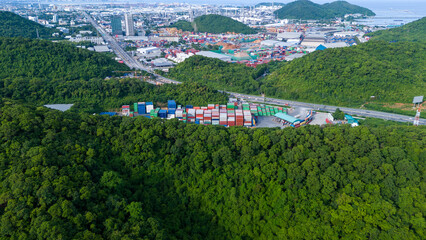 green transportation. Cargo Container yard next the road and surrounded by mountains , forklift...