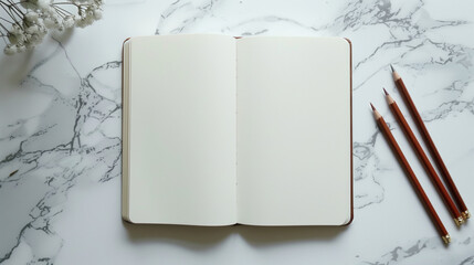 White Sketchbook with Brown Pencils on Marble Desk 