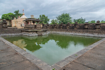 Elegant step-well known as Pushkarni. surrounded by a stone wall with 24 niches devkoshatas,...