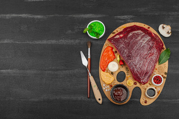 Gourmet food concept with raw flank steak, assorted spices, sauces, and herbs arranged creatively