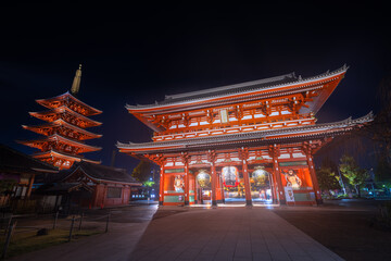 View of the vibrant red gate and pagoda illuminated against the dark sky, creating a captivating contrast of light and shadow, Tokyo, Tokyo, Japan.