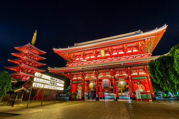 View of the vibrant red Senso-ji Temple complex, with its towering pagoda and ornate gates illuminated against the inky night sky, Tokyo, Tokyo, Japan.