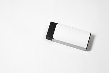 Sleek rectangular box with black and white design, isolated on white background.