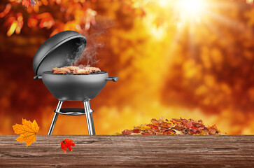 autumn time in backyard garden with grill BBQ, wooden table, blurred background