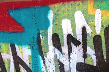 Vibrant abstract graffiti featuring red, blue, yellow on rough concrete. Urban 80s, contemporary style, bold colors, expressive strokes. Street art, murals, modern 90s creative visuals.