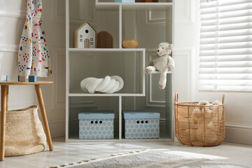 Stylish decor on shelves in playroom. Interior design