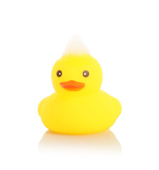 One cute rubber duck and foam on mirror surface against white background