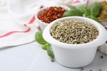 Different aromatic spices on white tiled table, closeup