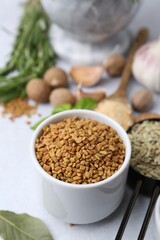 Different aromatic spices on light grey table, selective focus