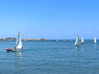 Sestri Levante, Italy - July 15, 2025. Sailboats in sea. Sport and sailing school for teenagers and adults. Nature and vacation in Italy. Leisure and seasons.