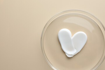Cosmetic product in Petri dish on beige background, top view. Space for text