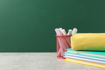 Stylish stationery on light desk against chalkboard. space for text