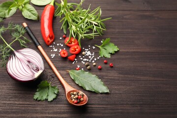Different fresh herbs and spices on wooden table, closeup. Space for text