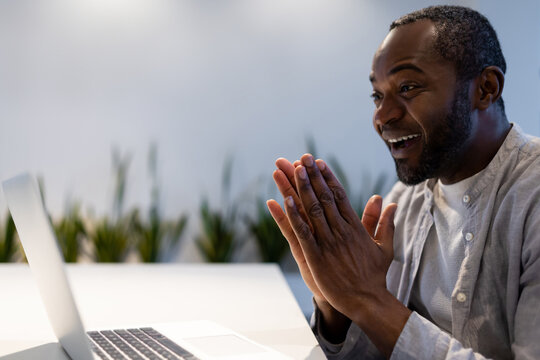 African American businessman participating in video call, discussing project performance in office