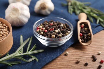 Different aromatic spices on wooden table, closeup