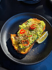 A plate of avocado toast with chilli.