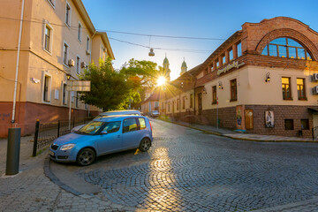 uzhhorod, ukraine - 04 jun 2017: european urban landscape with cars on street of town in morning...
