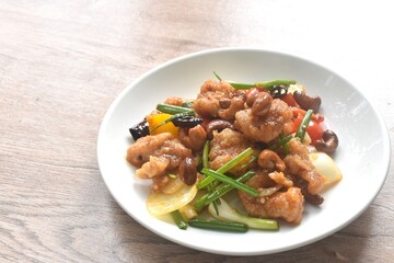 fried slice crispy chicken meat with cashew nut and bell pepper couple onion on plate 