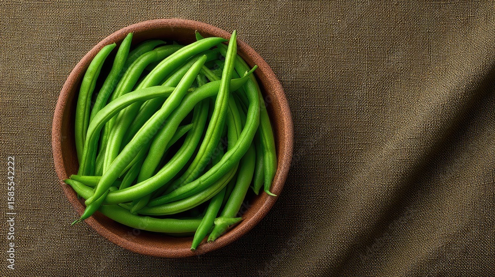 Poster a bowl of green beans placed in the corner of a textured linen background with generous copy space