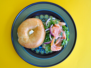 A salmon bagel with rocket and Spanish onion. 