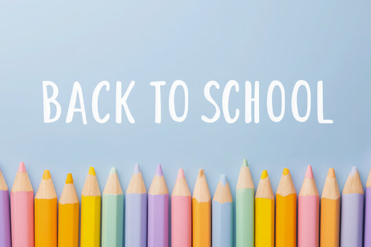 Back to School concept with a row of colorful pencils on a white background. Minimalist top view, flat lay design. A clean, creative banner for education, art, and school supplies.