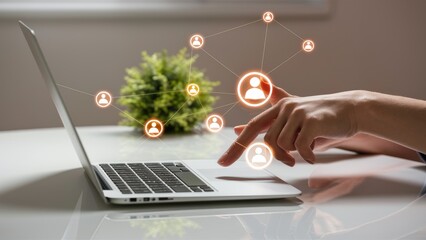 Networking Laptop with User Icons, Hand Using Interface on White Desk, Plant