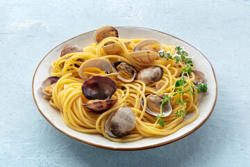 Vongole clams with spaghetti pasta. Seafood dish with thyme, Mediterranean cuisine
