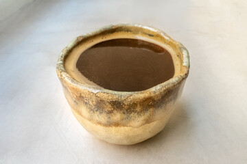 Americano coffee in a handmade ceramic cup at a cafe, atmospheric shot