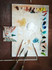 artist painting on canvas, paint palette, artist's workplace, oil paints