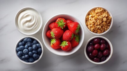 Top view of yogurt bowl ingredients including granola and berries, prepped with light space