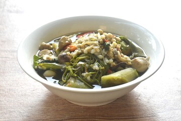 sweet Melientha suavis and mixed vegetable with red ant egg in fermenting fish sauce curry soup on bowl